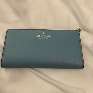NWOT: kate spade schuyler smoky blue large slim bi-fold wallet with silver logo